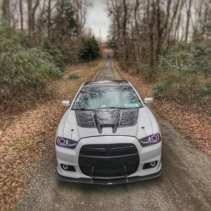 Front view of a Dodge Charger with white LED headlight halo rings installed.