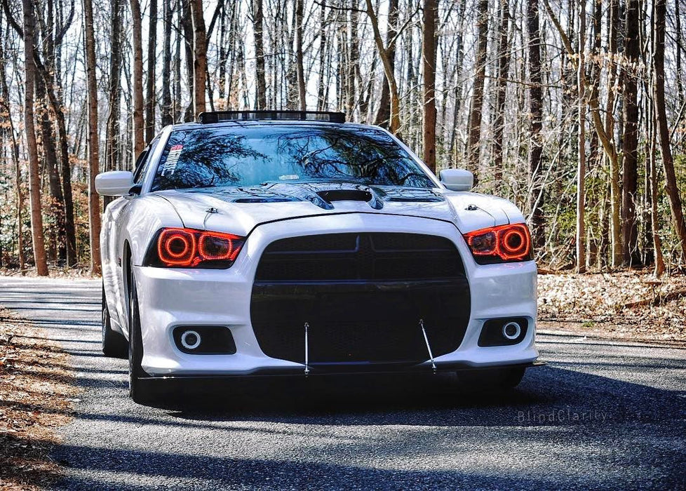 Front end of a white Dodge Charger with red LED headlight halo rings installed.