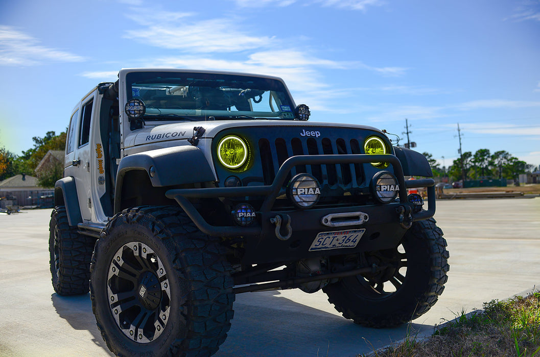Three quarters view of a Jeep Wrangler JK with yellow LED headlight halos installed.