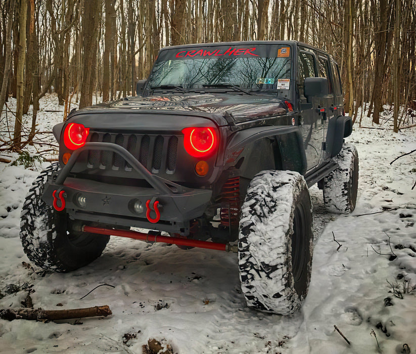 Three quarters view of a Jeep Wrangler JK with red LED headlight halos installed.