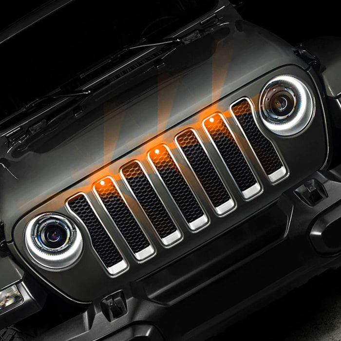 Front end of a Jeep Wrangler JL with amber Pre-Runner Style LED Grill Light Kit installed.