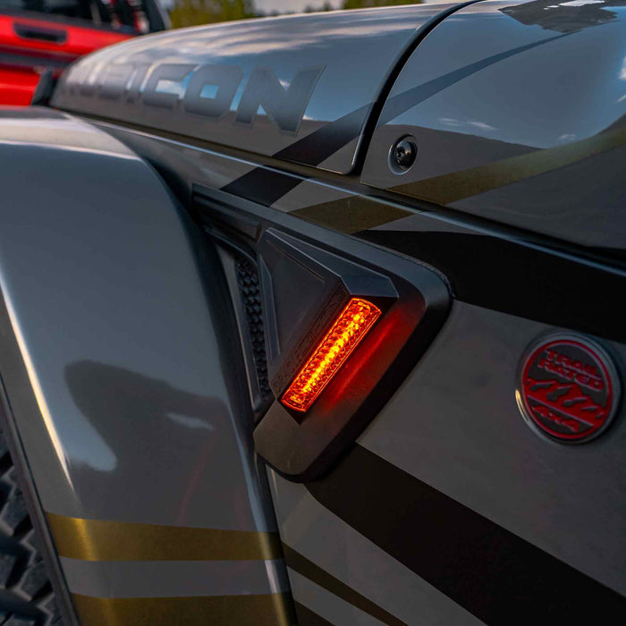 Close-up view of the Sidetrack LED Lighting System installed on a Jeep Wrangler JT, with amber LEDs on.