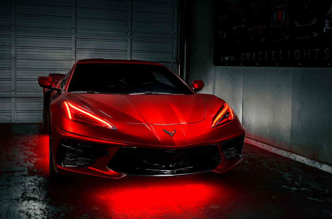 Red Corvette in a garage with red headlight DRLs.