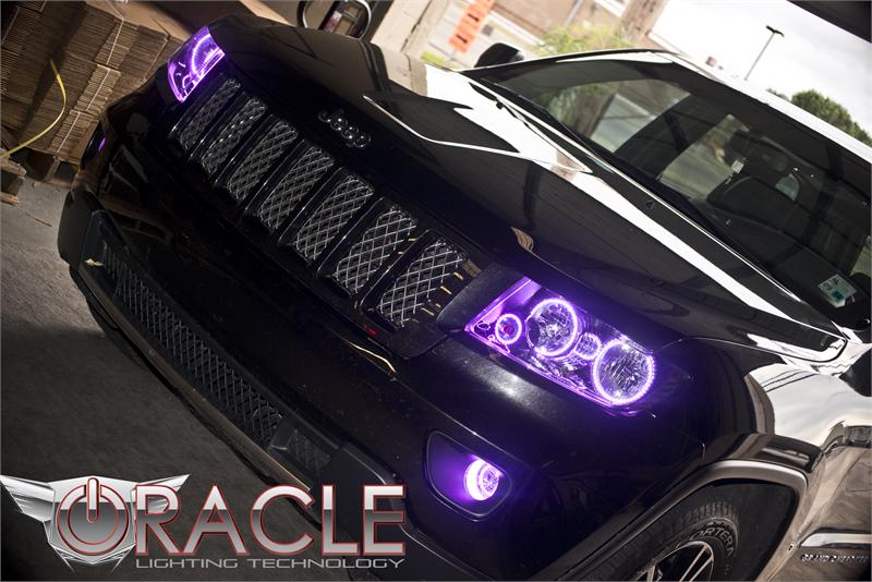 Front end of a Jeep Grand Cherokee with purple LED headlight and fog light halos.