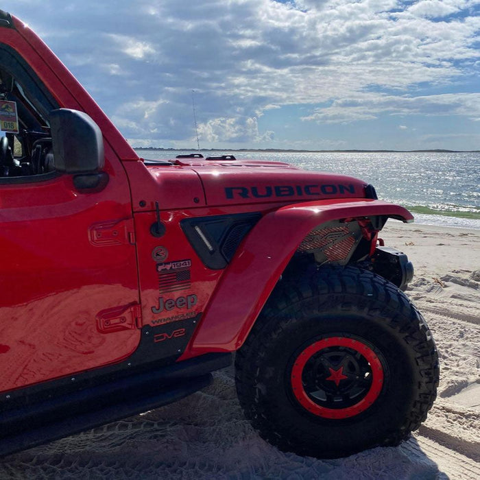 Side view of a Jeep Wrangler parked by the ocean, with Sidetrack™ LED Lighting System installed.