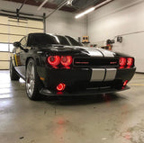 Three quarters view of a black Dodge Challenger with red LED headlight and fog light halo rings installed.