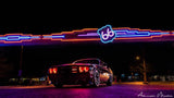 Low aggressive shot of a Dodge Challenger with red LED headlight halo rings installed.