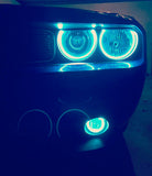 Close-up of cyan LED headlight and fog light halo rings installed on a Dodge Challenger.