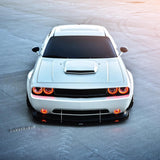 Front view of a white Dodge Challenger with red LED headlight and fog light halo rings installed.