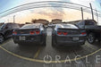 2 Chevrolet Camaros side by side in a parking lot, both with afterburner tail light halos installed