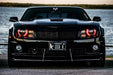 Front end of a Chevrolet Camaro with red LED headlight halo rings installed.