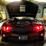 Front end of a Chevrolet Camaro with red LED headlight halo rings installed.