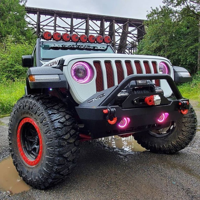 Front end of a Jeep with ColorSHIFT Oculus Headlights installed, with pink halo rings.