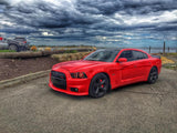 Three quarters view of a red Dodge Charger with red LED headlight and fog light halo rings installed.