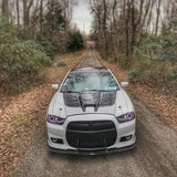 Front view of a Dodge Charger with white LED headlight halo rings installed.