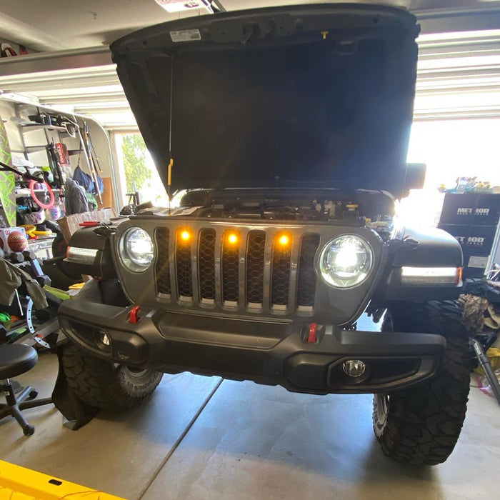 Front end of a Jeep Gladiator JT with amber Pre-Runner Style LED Grill Light Kit installed.