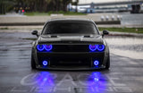 Front end of a Dodge Challenger with blue LED headlight and fog light halo rings.
