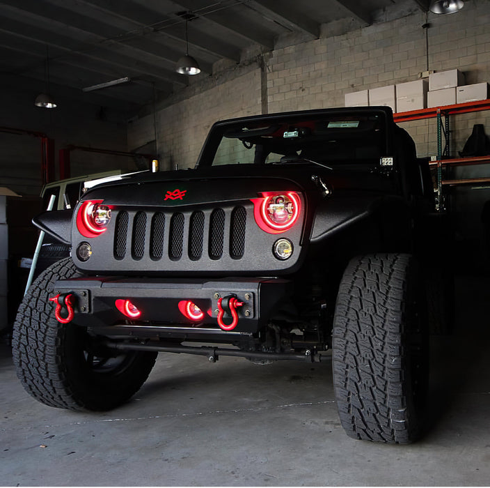 Front end of a Jeep Wrangler JK with red LED headlight and fog light halos installed.