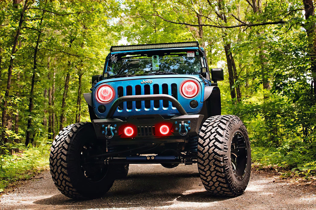 Front end of a Jeep Wrangler JK with red LED headlight and fog light halos installed.