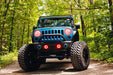 Front end of a Jeep Wrangler JK with red LED headlight and fog light halos installed.
