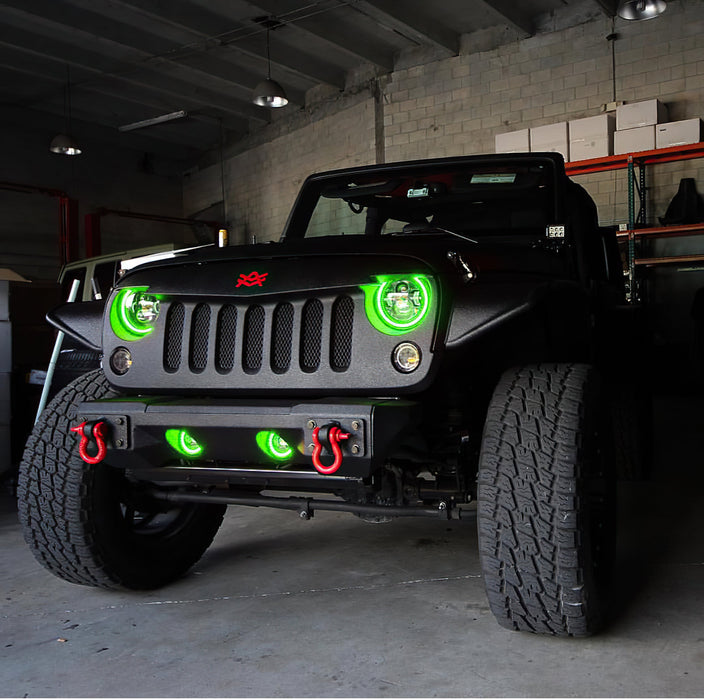 Front end of a Jeep Wrangler JK with green LED headlight and fog light halos installed.