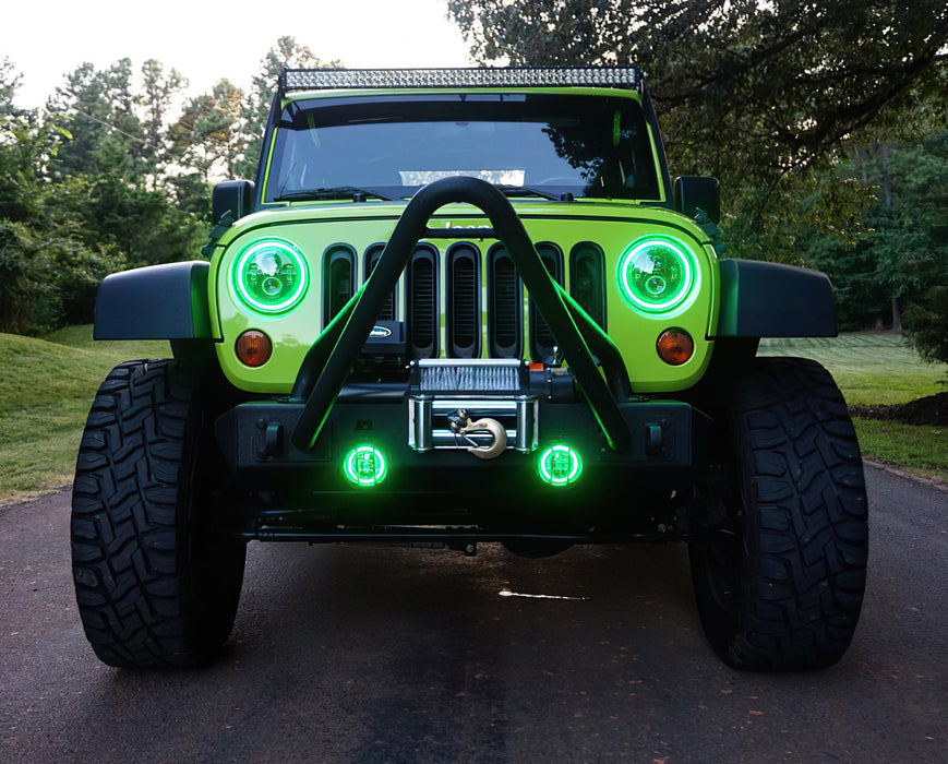 Front end of a Jeep Wrangler JK with green LED headlight and fog light halos installed.