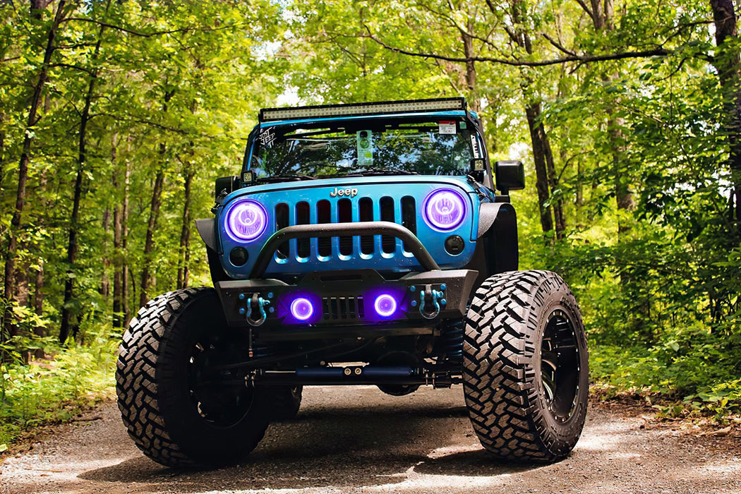 Front end of a Jeep Wrangler JK with purple LED headlight and fog light halos installed.