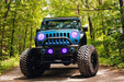 Front end of a Jeep Wrangler JK with purple LED headlight and fog light halos installed.