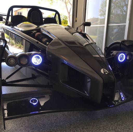 Ariel Atom with white headlight halos.