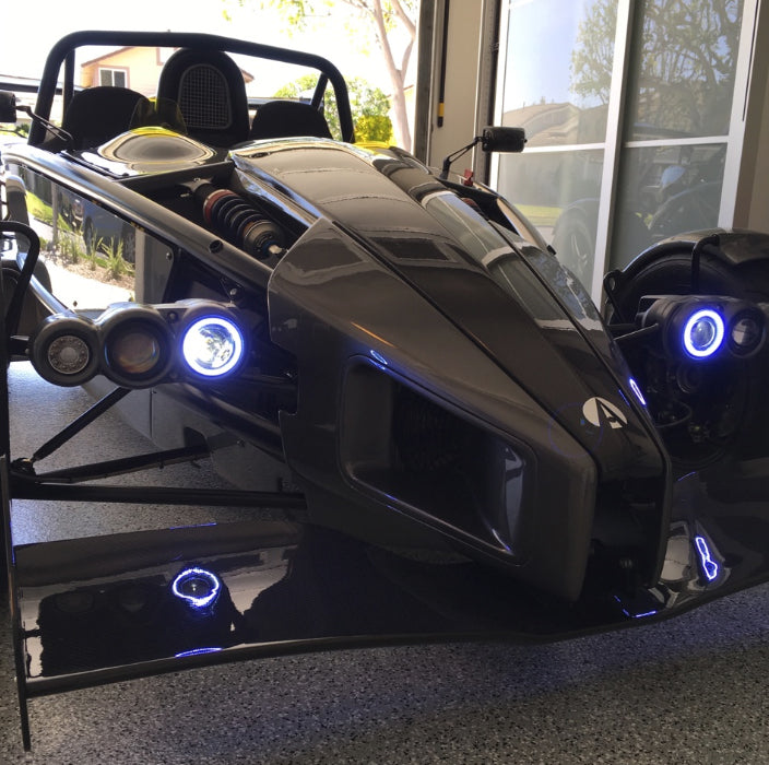 Ariel Atom with white headlight halos.