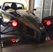Ariel Atom with red headlight halos.