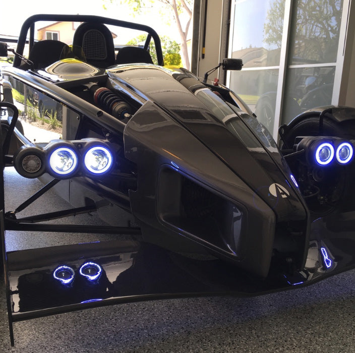 Ariel Atom with white headlight halos.