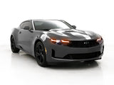 Three quarters view of a Chevrolet Camaro with amber headlight DRLs.