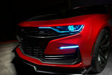 Front end of a red Chevrolet Camaro with cyan headlight DRLs.