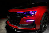 Front end of a red Chevrolet Camaro with pink headlight DRLs.