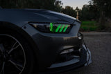 Close-up of a Ford Mustang headlight with green halos and DRLs.