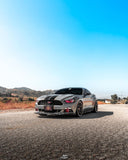 Three quarters view of a Ford Mustang with red headlight halos and DRLs.