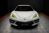 Front view of a white C8 Corvette with yellow headlight DRLs.