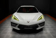 Front view of a white C8 Corvette with yellow headlight DRLs.