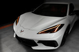 Front end of a white C8 Corvette with amber headlight DRLs.