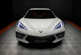 Front view of a white C8 Corvette with white headlight DRLs.