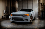 Three quarters view of a grey Dodge Charger with amber headlight DRLs.