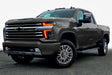 Three quarters view of a Chevy Silverado with amber headlight DRLs.