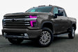 Three quarters view of a Chevy Silverado with pink headlight DRLs.