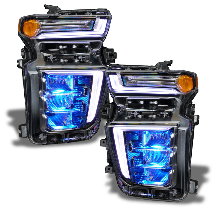 Chevrolet Silverado headlights with cyan demon eye projector.
