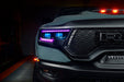 Close-up of Ram 1500 headlights with purple DRLs and cyan demon eye projectors.