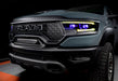 Front end of a Ram 1500 with yellow headlight DRLs and purple demon eye projectors.