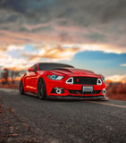 Three quarters view of a Ford Mustang with white LED headlight halos and DRLs.
