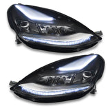 Tesla Model 3 headlights with white DRLs.