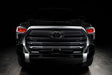  Straight front view of a black Toyota Tundra with red demon eye projectors.